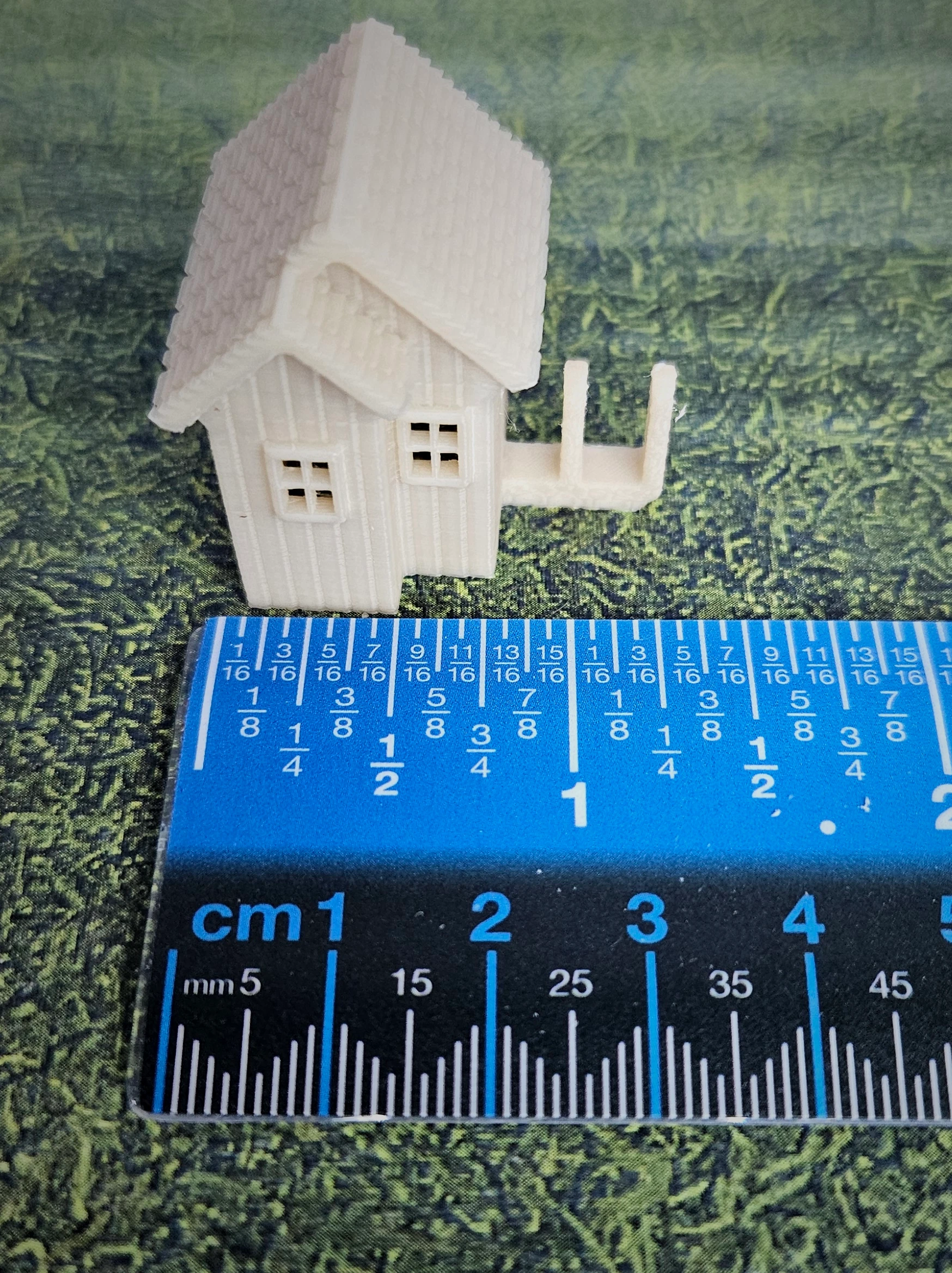 Painted example of N scale waterwheel with medium building